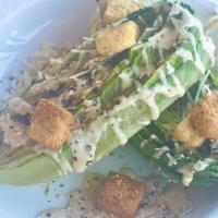 Chard Caesar · Grilled romaine hearts - Creamy Caesar - Parmesan cheese- Homestyle croutons