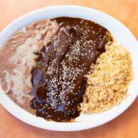 Mole · Corn tortilla filled with tender chicken with mole and sesame seeds.