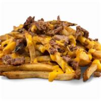 Brisket Cheese Fries · Fries smothered with jalapeño cheese sauce and topped with smoked chopped bacon.