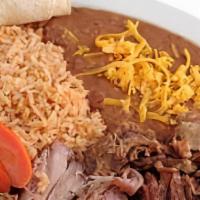 Carnitas · Served with rice, beans, tortillas, and cheese.