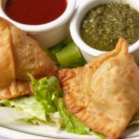 Vegetable Samosa · Two patties stuffed with potatoes and [peas.