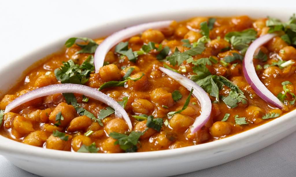 Channa Masala · Chick peas soaked overnight with potato cooked in fresh tomato onion and spices.
