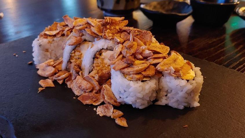 Salmon Temptation · Inside: spicy crab, shrimp tempura. Outside: salmon, avocado, fried onion, green onion, tobiko. Sauce: eel, spicy mayo.