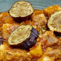 Pork Binagoongan · Pork sautéed in bagoong alamang (shrimp paste), garlic, tomatoes, and eggplant.
