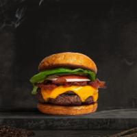 Bussin' Bacon Burger · Seasoned plant-based patty topped with melted vegan cheese, layers of crispy vegan bacon, le...