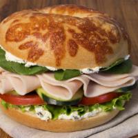 Tasty Turkey Sandwich · Asiago Bagel with turkey, spinach, cucumber, lettuce, tomato and onion and chive shmear.