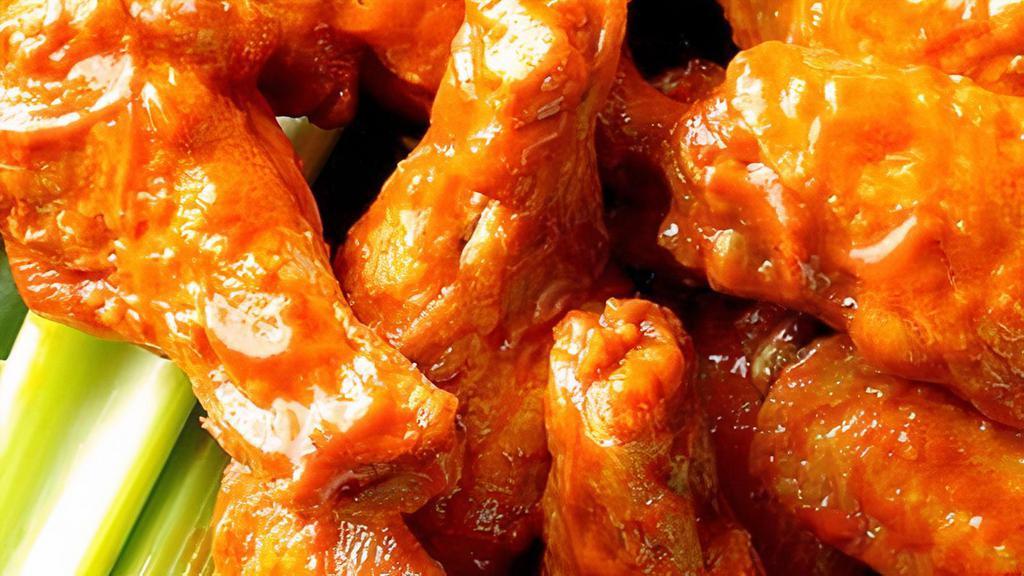 Buffalo Wings · Most popular. Tossed in buffalo sauce. Served with carrots, celery sticks, ranch dressing, and blue cheese dressing.