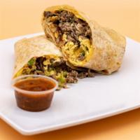Machaca Breakfast Burrito · Shredded beef, grilled onions, bell peppers, tomatoes, eggs, fresh hashbrowns, and melted sh...