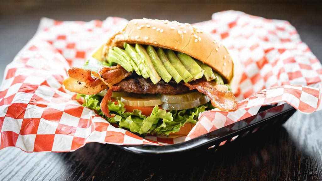 Bacon Avocado Burger · Bun, hamburger patty, crispy bacon, fresh avocado, onions, lettuce, tomato, pickles, and our signature 1000 Island dressing.