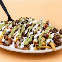 Carne Asada Fries · French fries covered in carne asada, refried beans, melted shredded cheese, pico de gallo, s...
