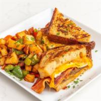 Breakfast French Toast Sandwich · Turkey sausage, fried egg, bacon, and cheddar on sourdough bread served with breakfast potat...
