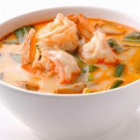 Tom Yum Kung · Spicy and sour soup with shrimp, mushrooms and lemon grass, garnished with green onions and ...