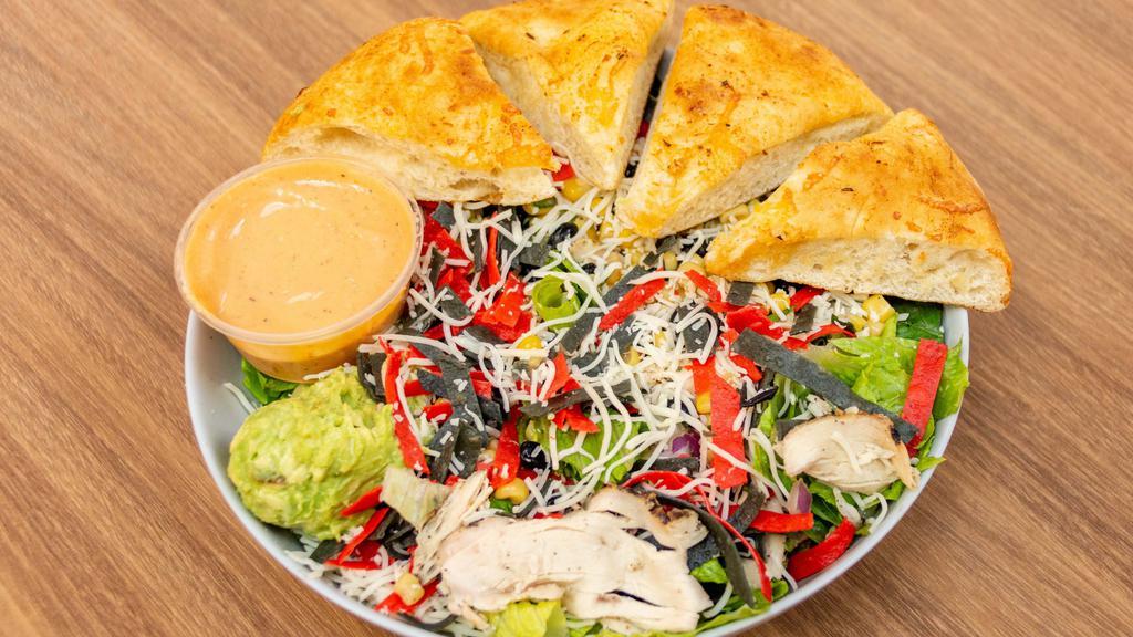 Southwest Chicken Caesar Salad · Romaine lettuce, grilled chicken, spicy Caesar dressing, avocado, black beans and corn salsa, Parmesan cheese and tortilla strips.