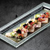 Yellowtail Carpaccio · Yellowtail sashimi, truffle oil, jalapeno, sesame seeds, tobiko, and yuzu citrus.