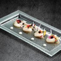 Japanese Scallop Carpaccio · Japanese scallop sashimi, lychee mayo, sea salt, tobiko, and yuzu citrus.