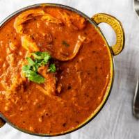 Butter Chicken · Boneless chicken cooked in a creamy tomato sauce with fresh herbs and spices.