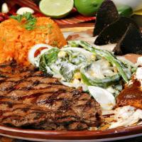 Carne Asada A La Tampiqueña · Grilled flap steak accompanied with a chicken mole enchilada.