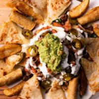 Fiesta Platter · Guacamole, nachos, quesadilla and taquitos.