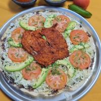 Tlayuda Regular · Large handmade tortilla with spreaded refried beans, cabbage, cheese, tomato, avocado, setti...