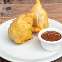 Vegetable Samosa · Deep fried patties stuffed with spices, potatoes, and green peas. Served with tamarind sauce.