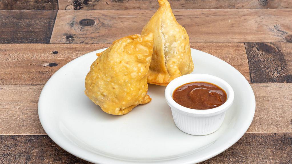 Vegetable Samosa · Deep fried patties stuffed with spices, potatoes, and green peas. Served with tamarind sauce.