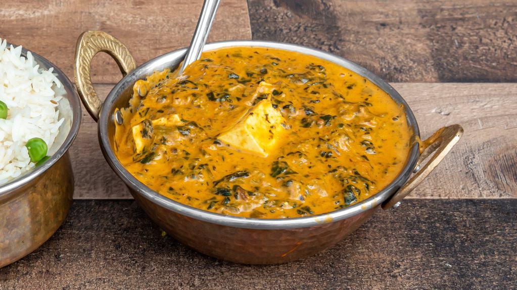 Palak Paneer · Minced spinach with homemade cottage cheese cubes in a light creamy sauce.
