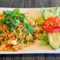 Coconut Shrimp Fried Rice · Topped with a sunny-side up fried egg and coconut grilled shrimp served with scallion broth.