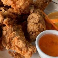 Fried Chicken · Chicken dipped in batter and deep-fried until golden brown, served with sweet and sour sauce.