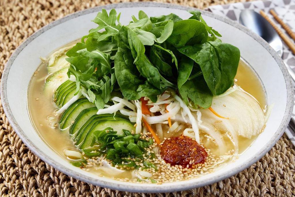 Miso Ramen · Miso broth, ramen noodles, onions, zucchini, coleslaw, spinach, arugula, red hot chili garlic, green onions and sesame seeds.