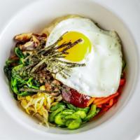 Bibimbap · Korean style rice bowl mixed with vegetables, beef and spicy koreans pepper sauce topped.