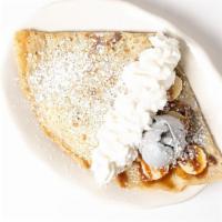 Crêpe Gourmande · Banana, house made caramel, pecan, vanilla gelato and whipped cream.