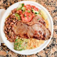 Carne Asada ( Grilled Steak ) · Grilled Steak served with rice, beans, and salad .