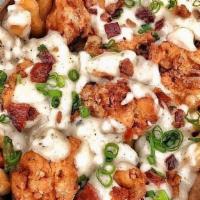 Country Fried Chicken · Country sausage gravy, chicken nuggets, bacon, cheese curds, and green onions (contains pork).
