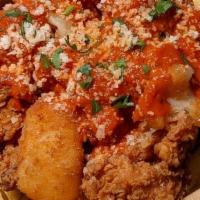 Chicken Parmesan Poutine · Chicken nuggets, fried cheese curds, marinara, parmesan cheese and parsley.
