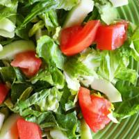 Tossed Green Salad · Vegan. Gluten-free. Fresh romaine lettuce, cucumbers and tomatoes tossed in our homemade dre...