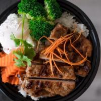 Moo-Ping Bowl · Marinated BBQ pork serve on jasmine rice, steamed broccoli and carrot top with cilantro.