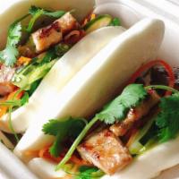 Bbq Pork Bowl Bun · Steamed bao bun wrapped with wakame-seaweed, pickled cucumber and carrot, cilantro.