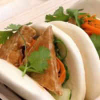Seasoned Tofu Bowl Bun · Steamed bao bun wrapped with wakame-seaweed, pickled cucumber and carrot, cilantro.