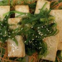Grilled Tofu Salad Bowl · Green leaf lettuce, shredded carrot, red onions, and wakame-seaweed.