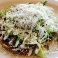 Sope · Sope con frijol, carne, queso, lechuga, tomate y cotija. / Sope with beans, meat,cheese, let...