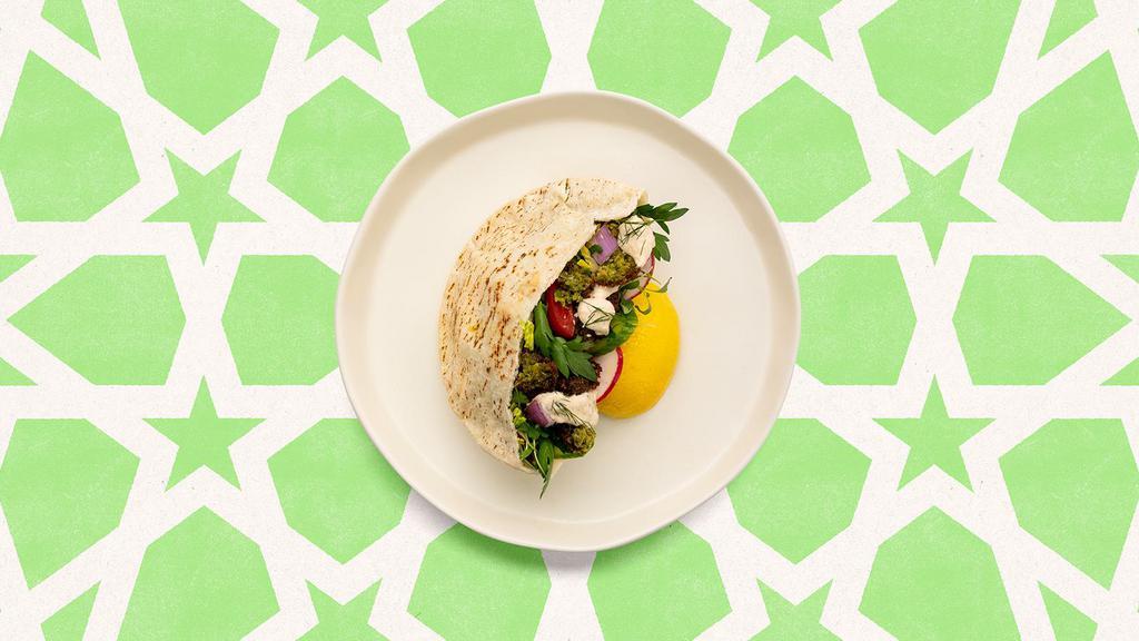 Falafel Baba Ghanoush Pita · Fresh falafel served in a pita with baba ghanoush, cucumber, lettuce, tomatoes, onions and tahini.