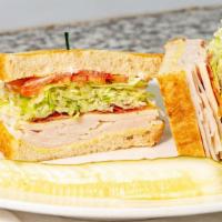 The Club · Mayo, mustard, turkey, bacon, swiss cheese, freshly cut lettuce, tomatoes and red onions on ...