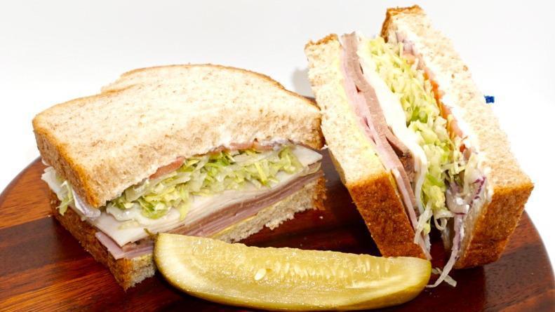 Deli Deluxe · Mayo, mustard, roast beef, turkey, ham, freshly cut lettuce, tomatoes and red onions on your choice of white, whole wheat, rye or sourdough bread