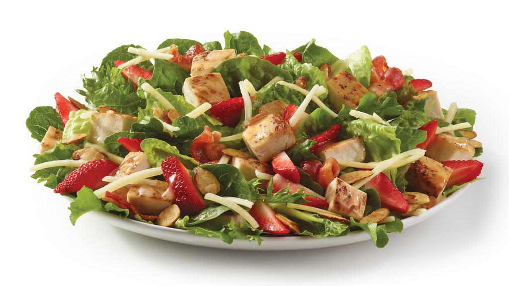 Summer Strawberry Salad · Made fresh daily with our Wendy’s® signature lettuce blend, herb-marinated grilled chicken breast, a three-cheese blend of Parmesan, Asiago, and Romano, Applewood smoked bacon, and, of course, strawberries. All topped with candied almonds and Marzetti® Champagne Vinaigrette. Raise a glass because this tasty of a salad deserves a toast.