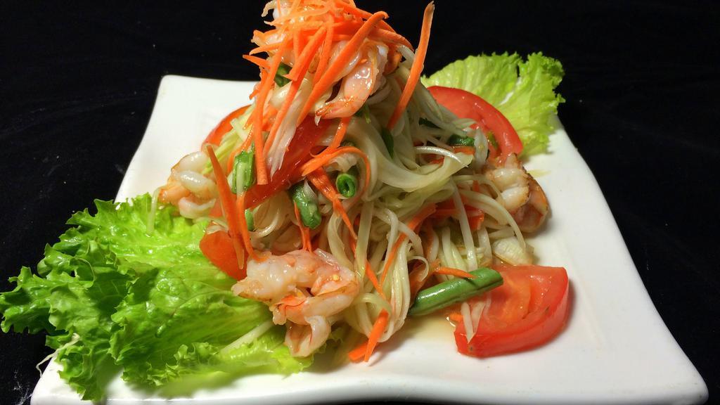 Papaya Salad ( Som Tam ) · Regular spicy. Shredded green papaya, tomato, green bean, carrot seasoned with a spicy house dressing, topped with peanuts.