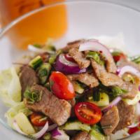 Beef Salad · Spicy. Grilled beef with onion, cucumber, mint, cilantro, and tomato tossed with spicy lime ...