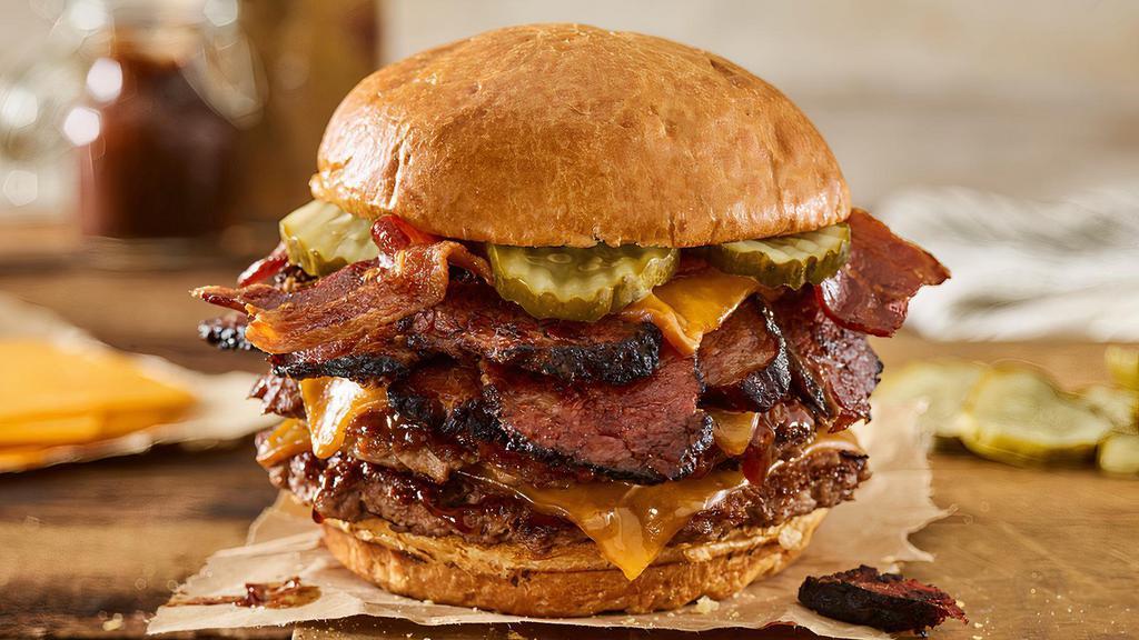 Double Smoked Bacon Brisket Burger · Double Certified Angus Beef, smoked aged cheddar cheese, brisket, applewood smoked bacon, pickles, bbq sauce, toasted brioche bun