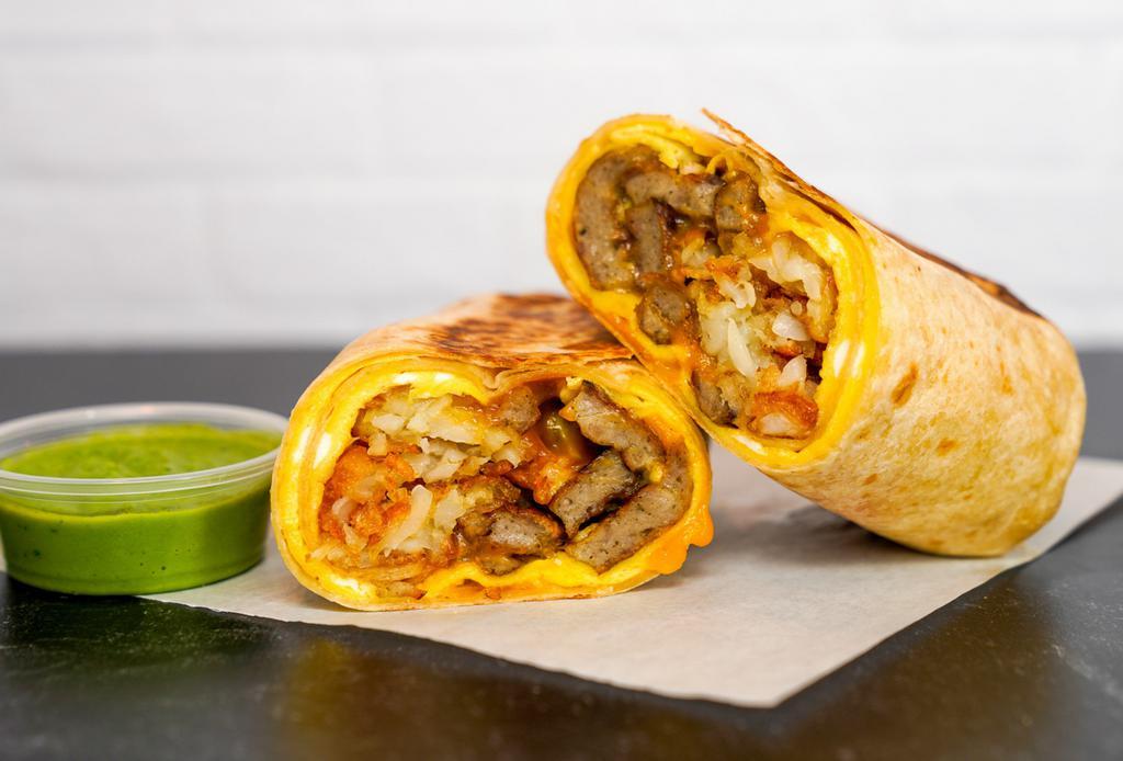 Sausage, Egg, And Cheddar Breakfast Burrito · 3 fresh cracked, cage-free scrambled eggs, melted Cheddar cheese, seared pork sausage patties, and crispy potato tots wrapped in a toasted 12” flour tortilla. Comes with avocado salsa verde side.