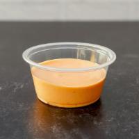 Sriracha Aioli Side · Mild-Medium spice level sriracha aioli with a splash of lime juice.