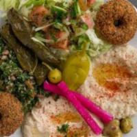 Mix Veggie Plate · Falafel, hummus, baba ganouj, salad, grape leaves, tabbouleh, and pita bread.